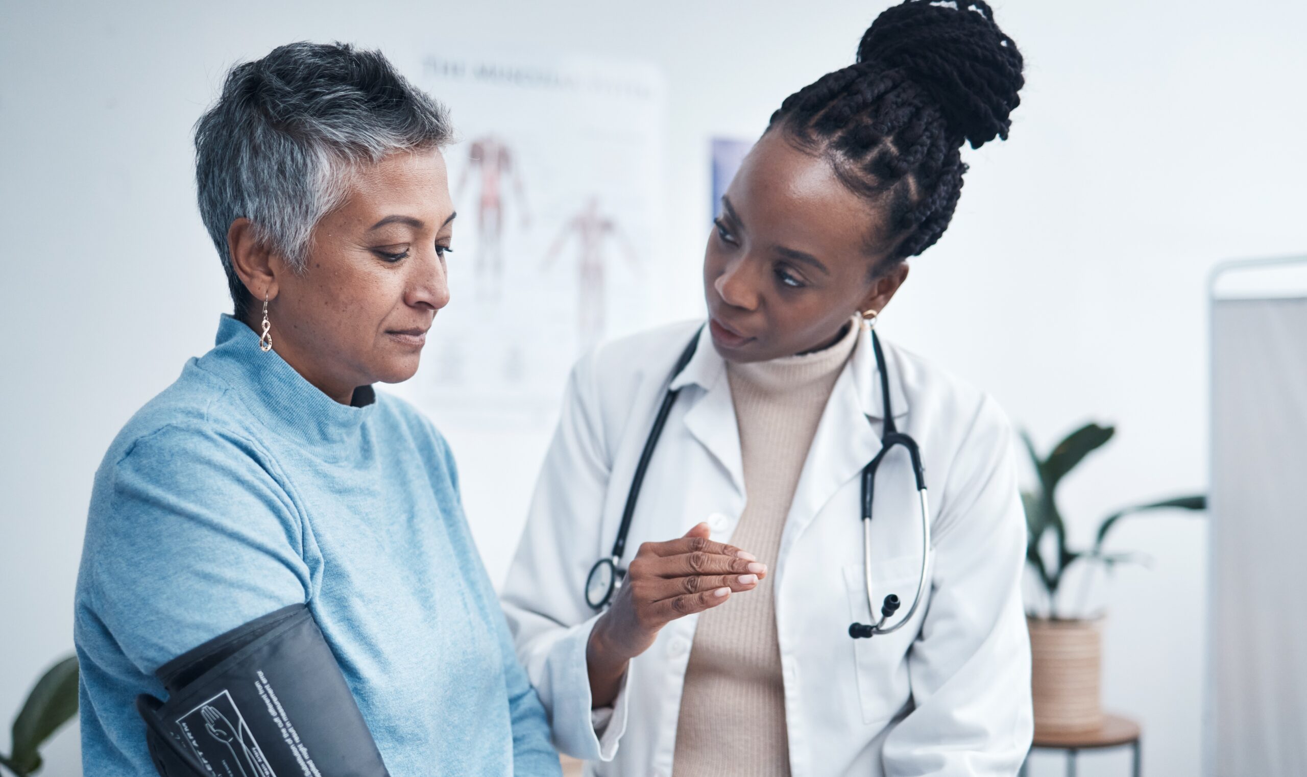 Black woman, doctor and senior patient with blood pressure reading